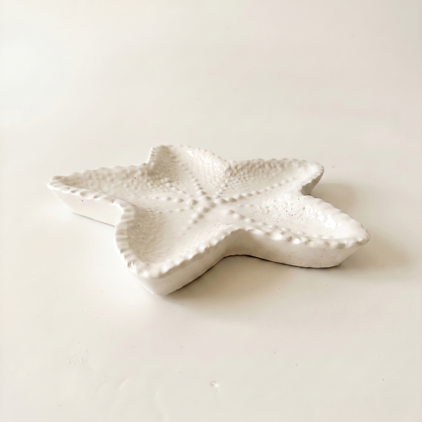 Starfish Tray gypsum white held in hand showing 4 inch scale — coastal decor | Sunsum